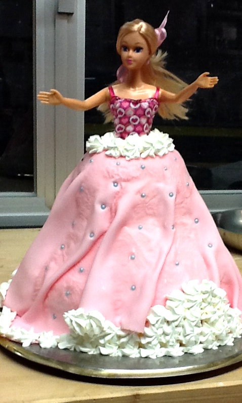 a doll is in a dress made out of fondant