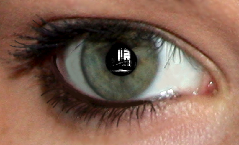 the reflection of someones eye with an ad in it
