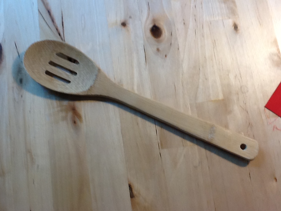 a wooden spoon with a fork is on a table