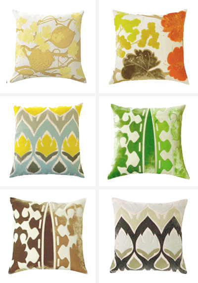 a bunch of different colored pillows with some design on them