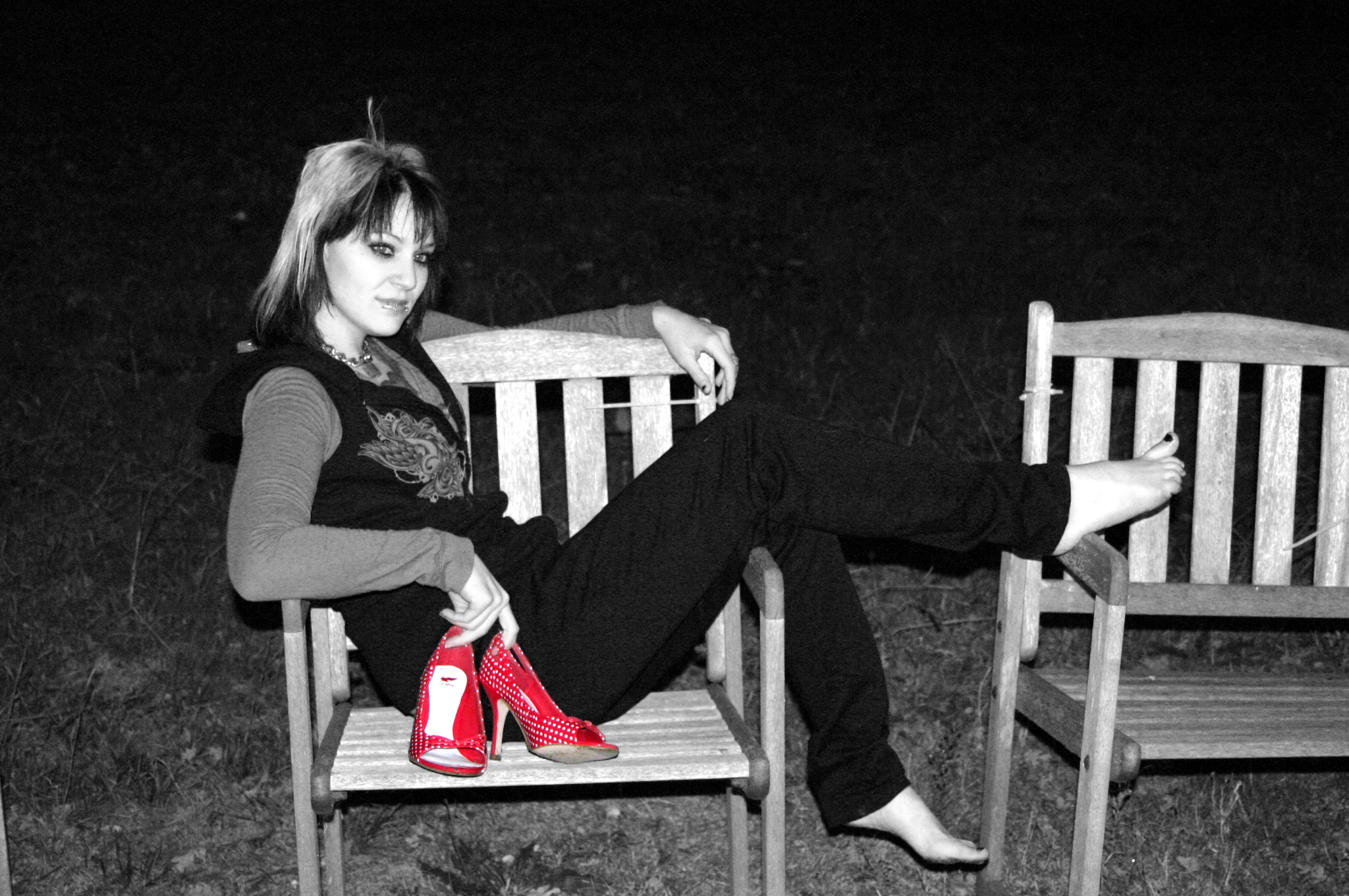 a young woman is sitting on a wooden bench