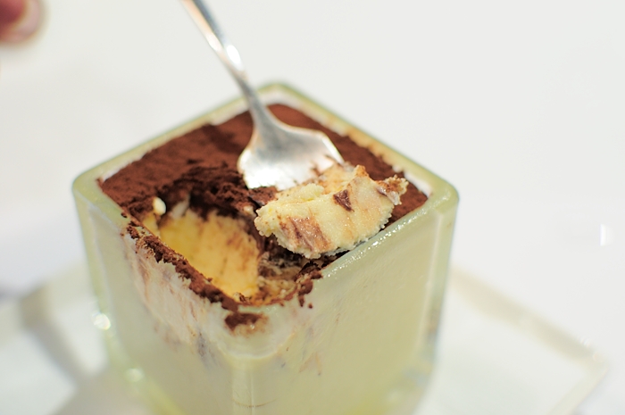 a spoon with some dessert in it on a plate