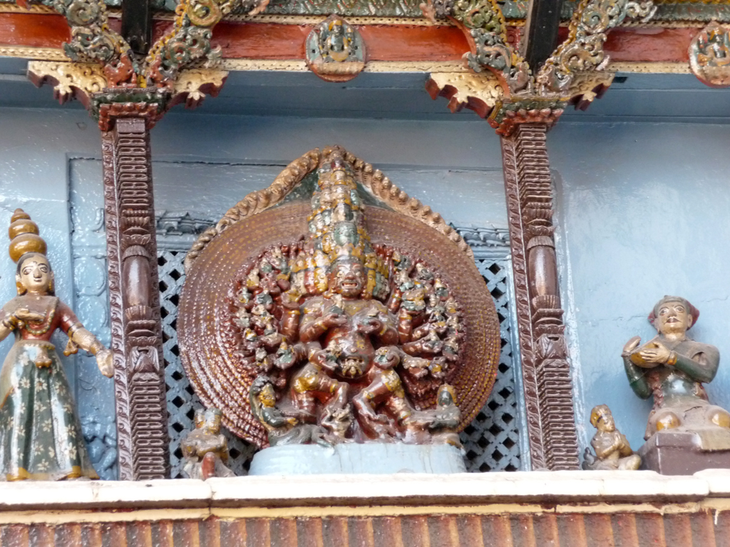 the statue of buddha in front of a blue wall