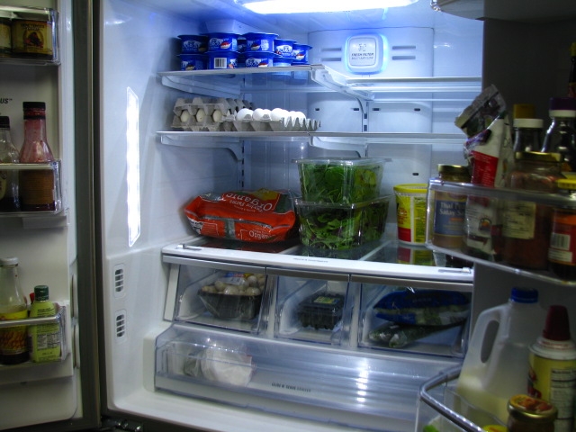 an open refrigerator with the door wide open