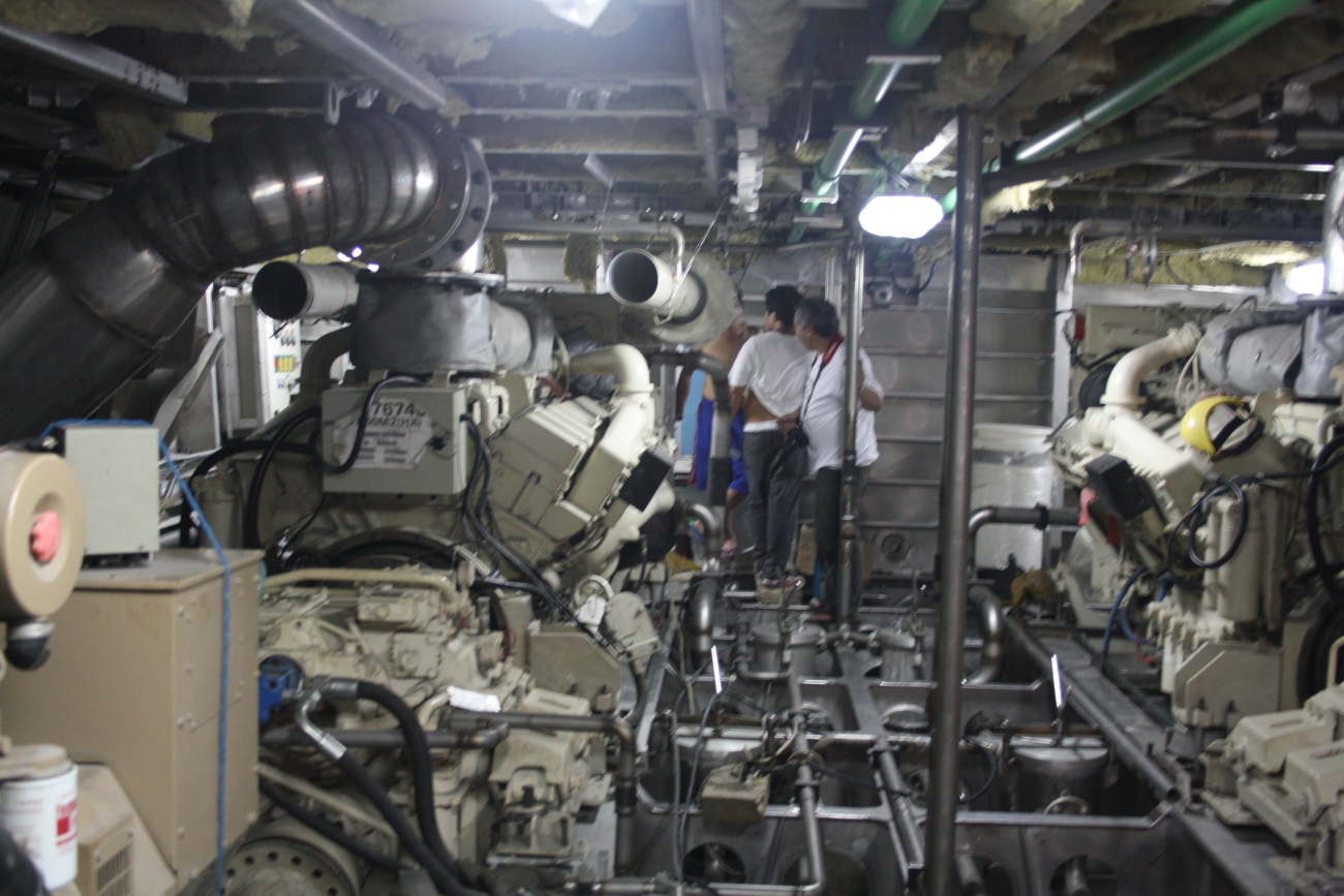 two men are inspecting machinery in the process