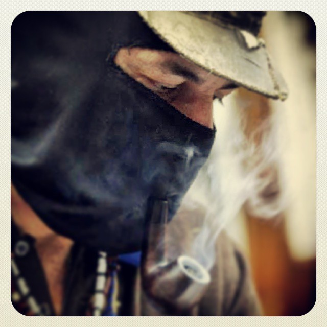 a man in black mask with smoke coming out his mouth