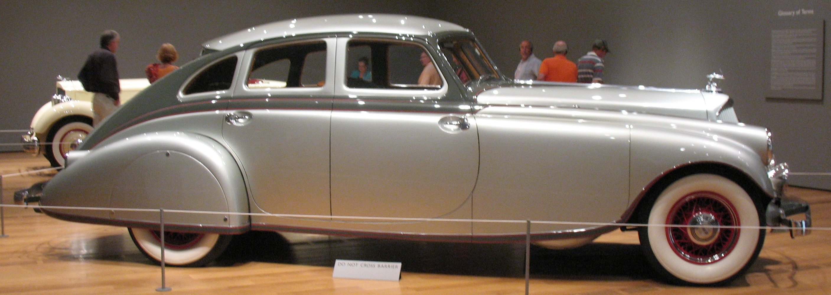 there is an antique car on display at the museum