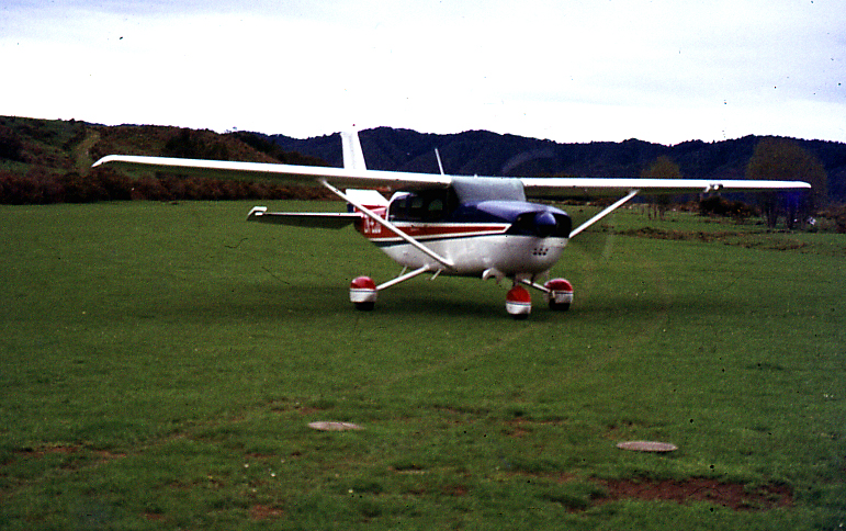 a small plane is sitting on some green grass