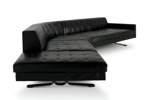 an unusual looking black sofa with ottoman