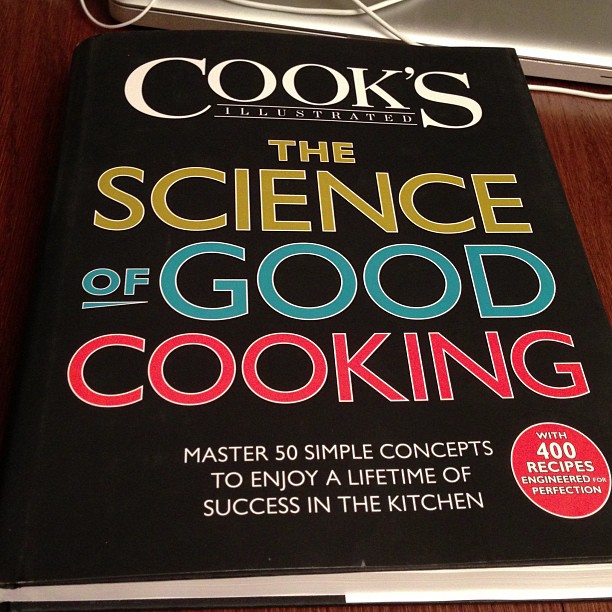 a cook's book sitting on top of a wooden desk