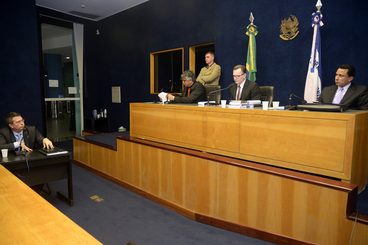 a group of people sitting around a wooden table