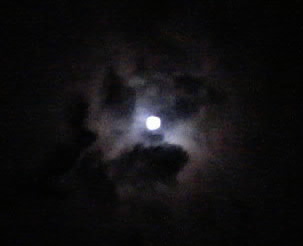 a cloud that is partially obscured by the moon