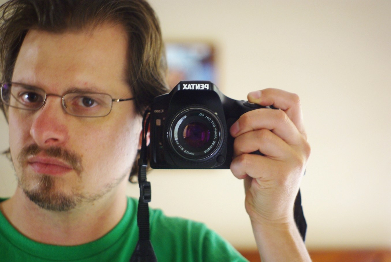 a man holding a black camera with his hand