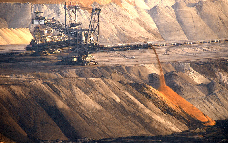 a large drill rig is sitting at an open pit