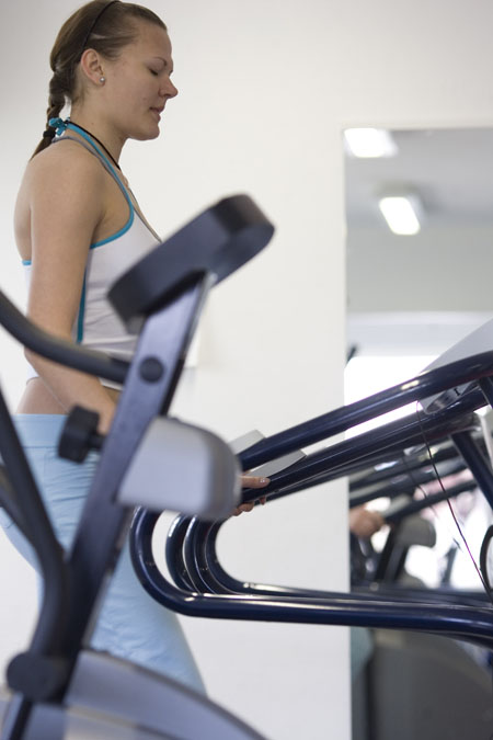 a woman walking on the treads of a treadmill