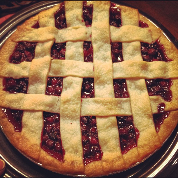 an individual holds a homemade cherry pie