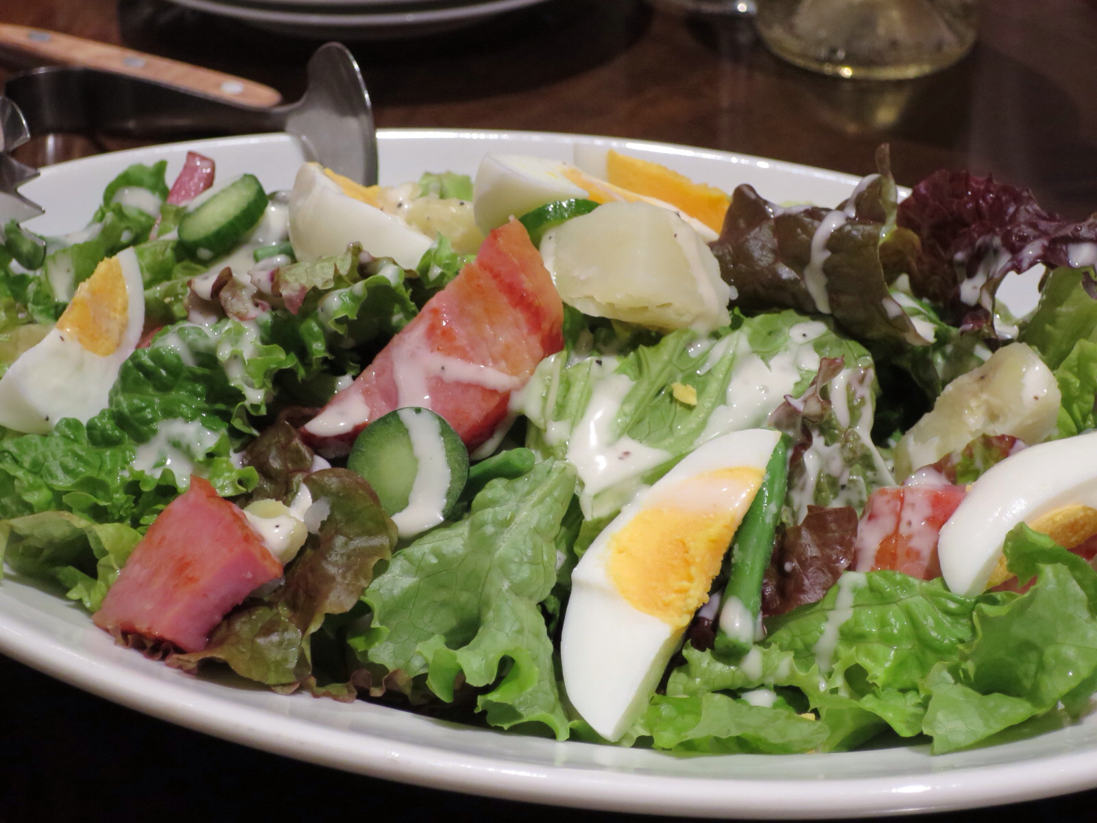 salad is shown with fruit and an egg