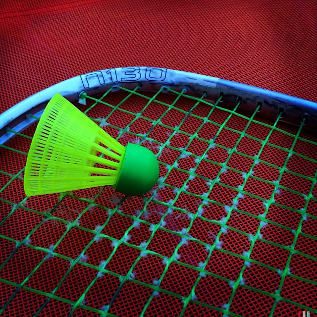 the tennis racket has a plastic yellow funnel