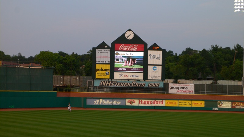an empty ballpark with billboards at the top of it