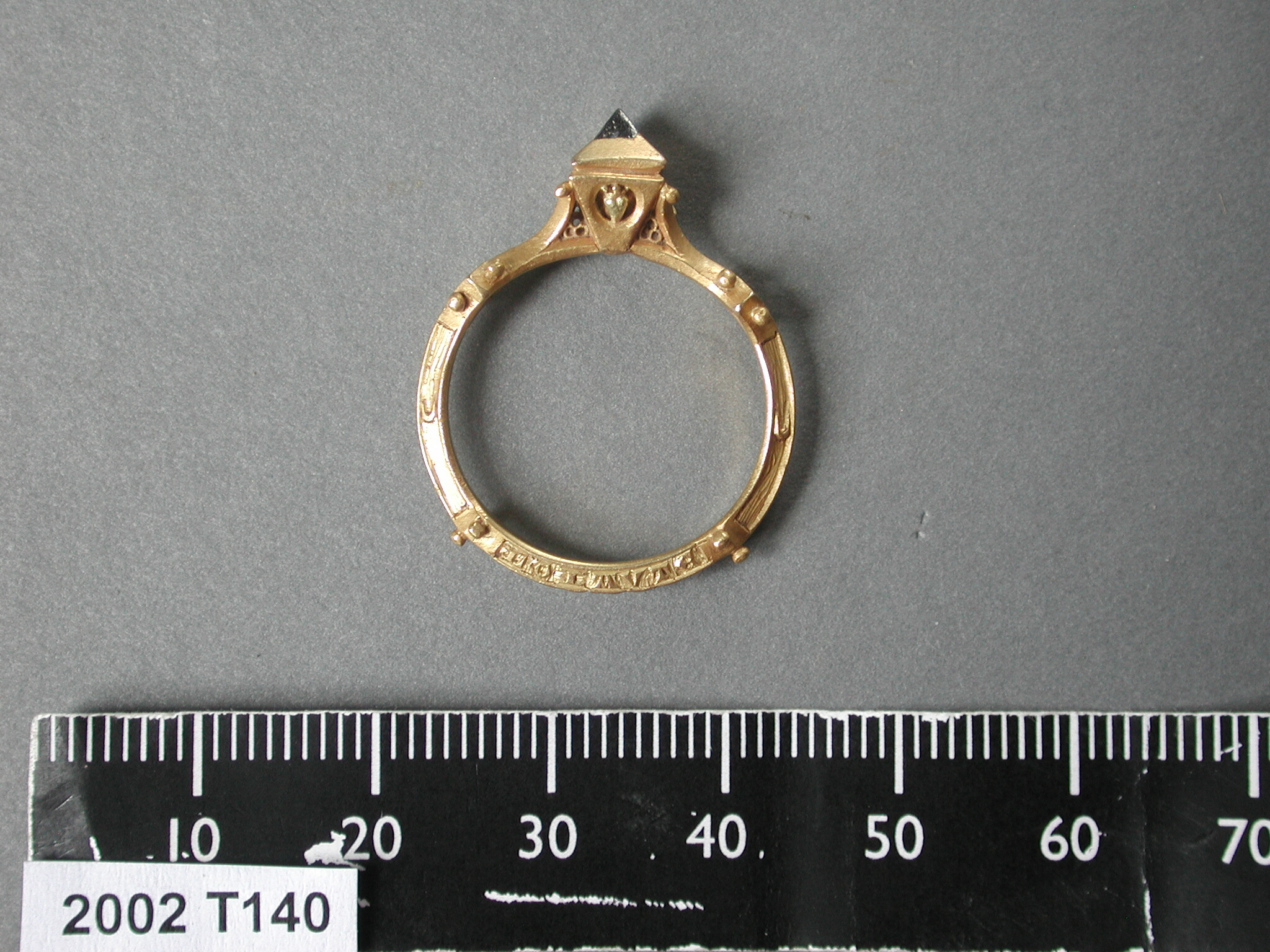 a close up of an engagement ring with a ruler on the side
