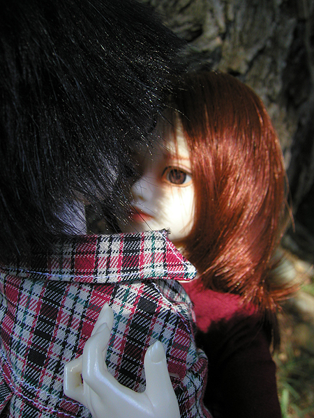 the back end of a doll with a checkered jacket on