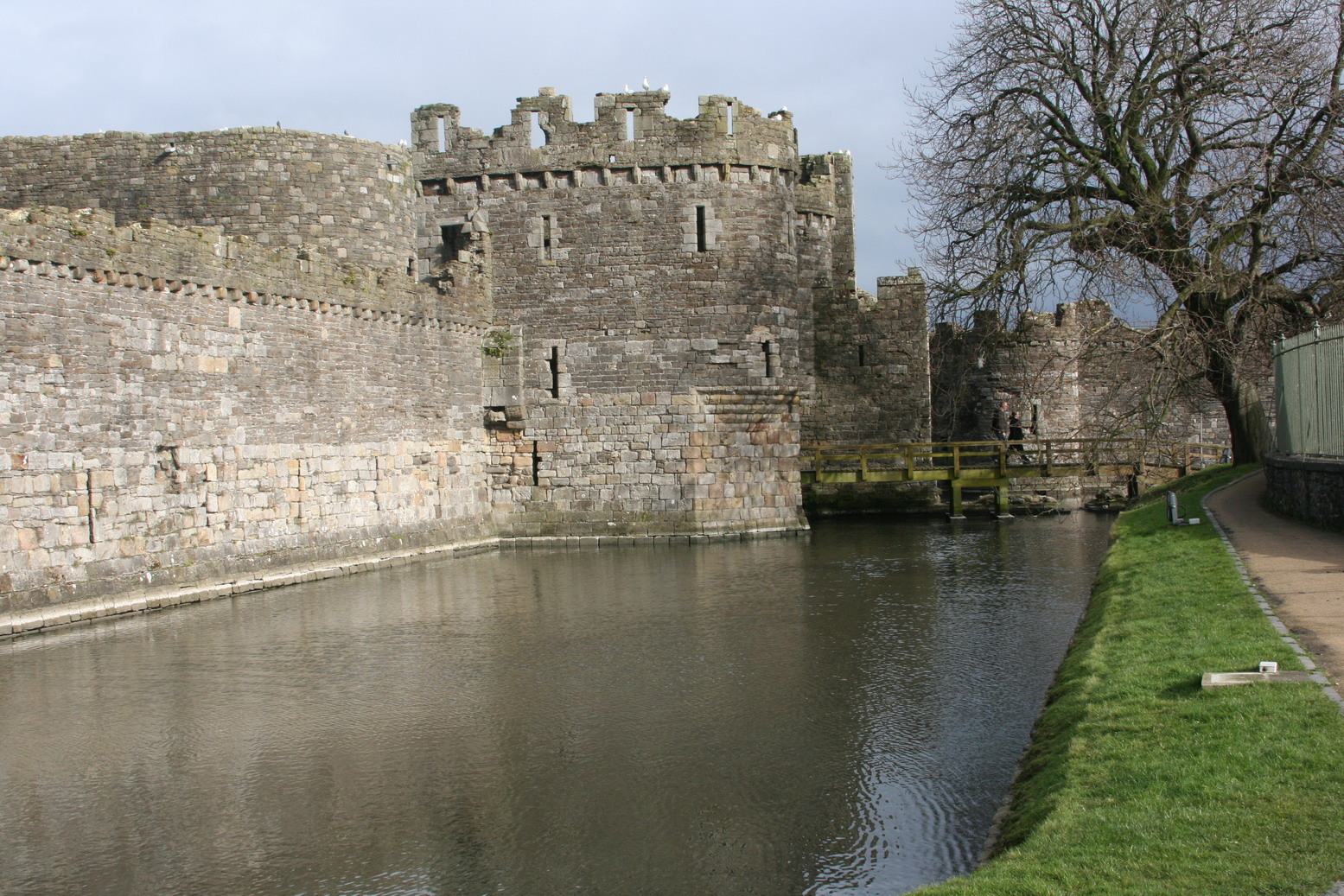a water way next to a castle wall