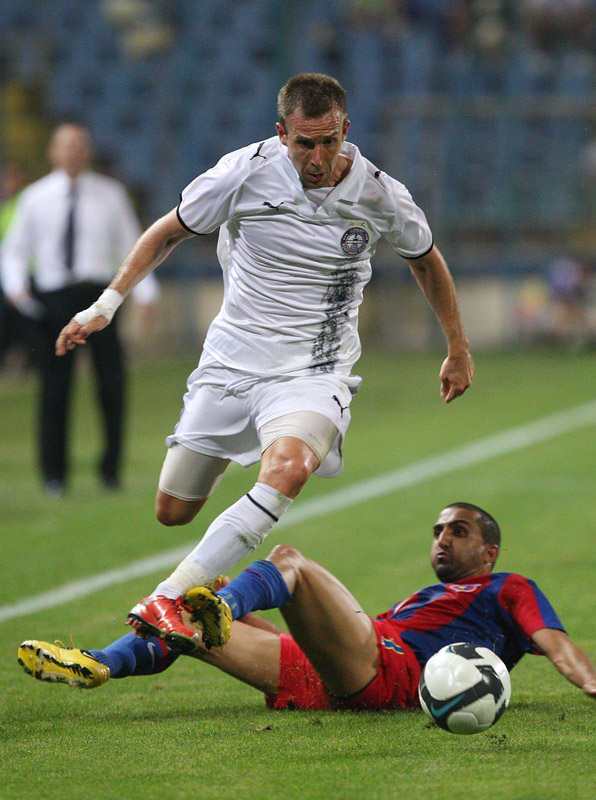 two soccer players are battling for control of the ball