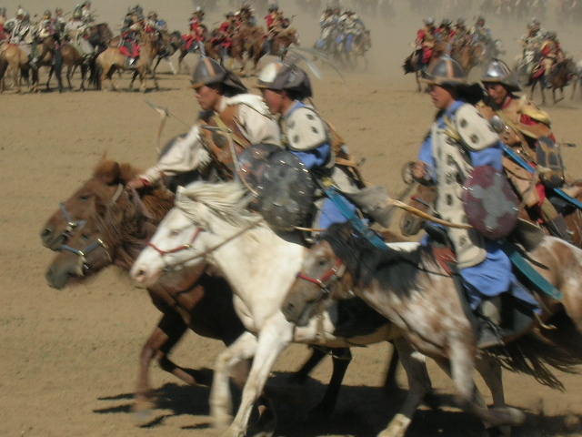 two men with armor are riding horses together
