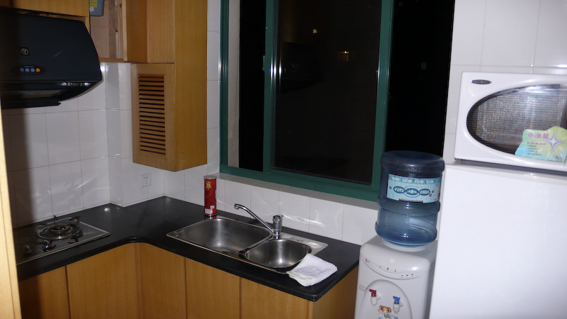 a kitchen with a sink, dishwasher and microwave