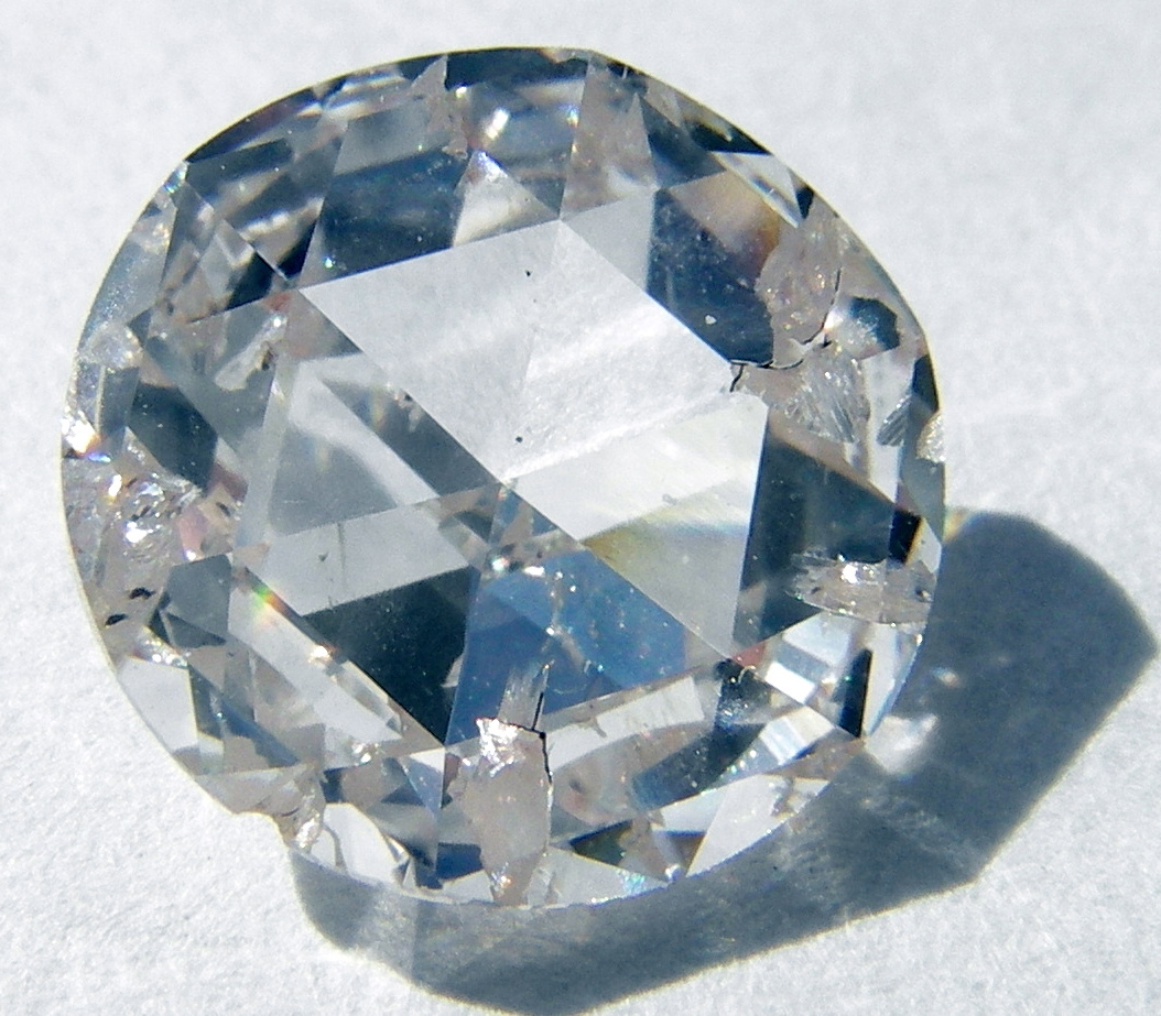 a very large fancy looking diamond sitting on a white surface