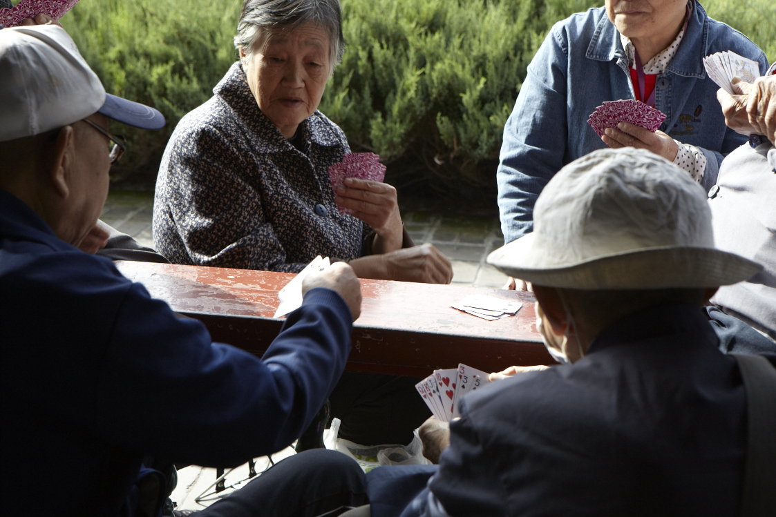 women sitting at a table playing cards