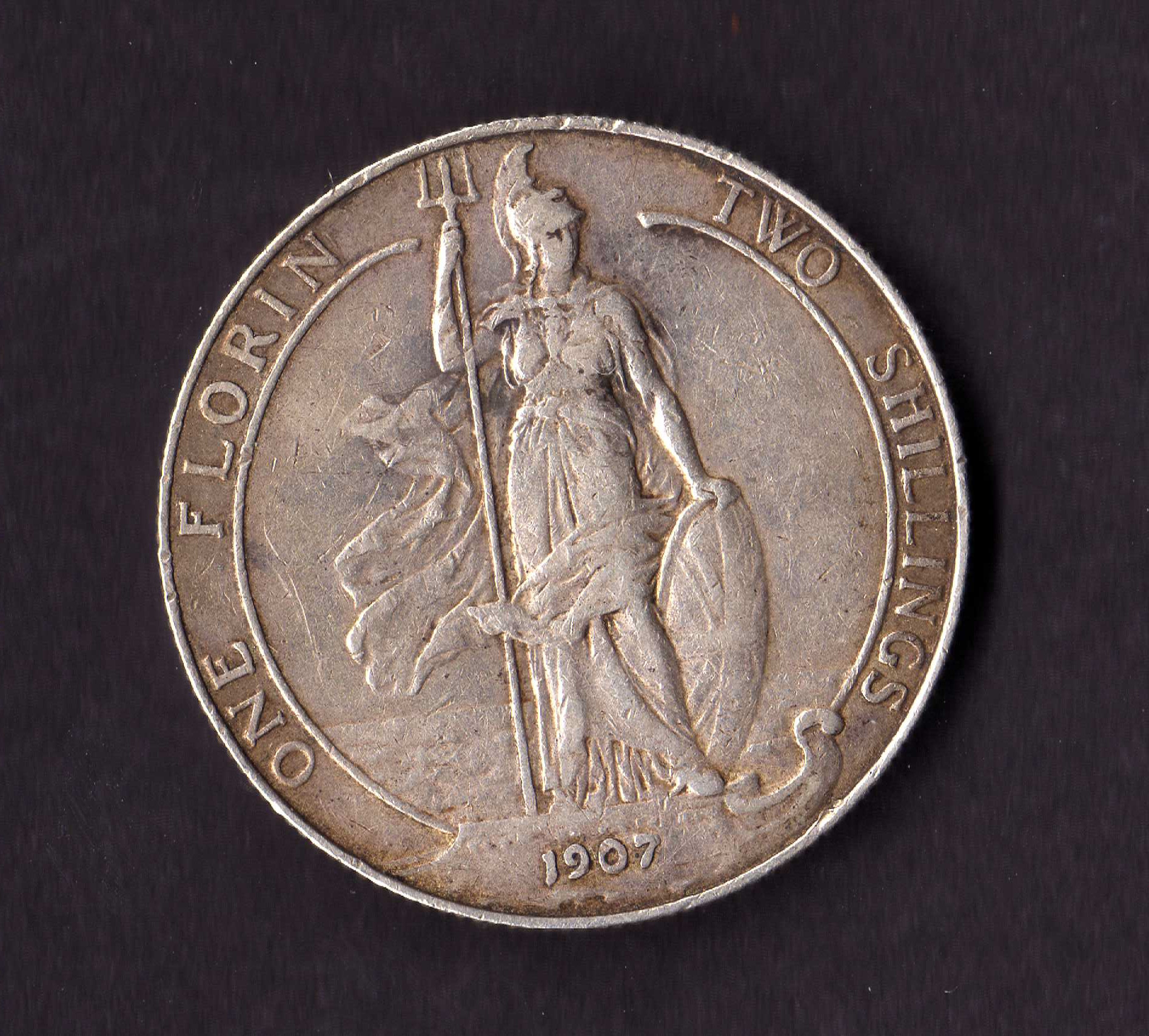 a coin with an old statue on the top