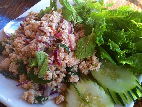 some green leaves and vegetables on a white plate