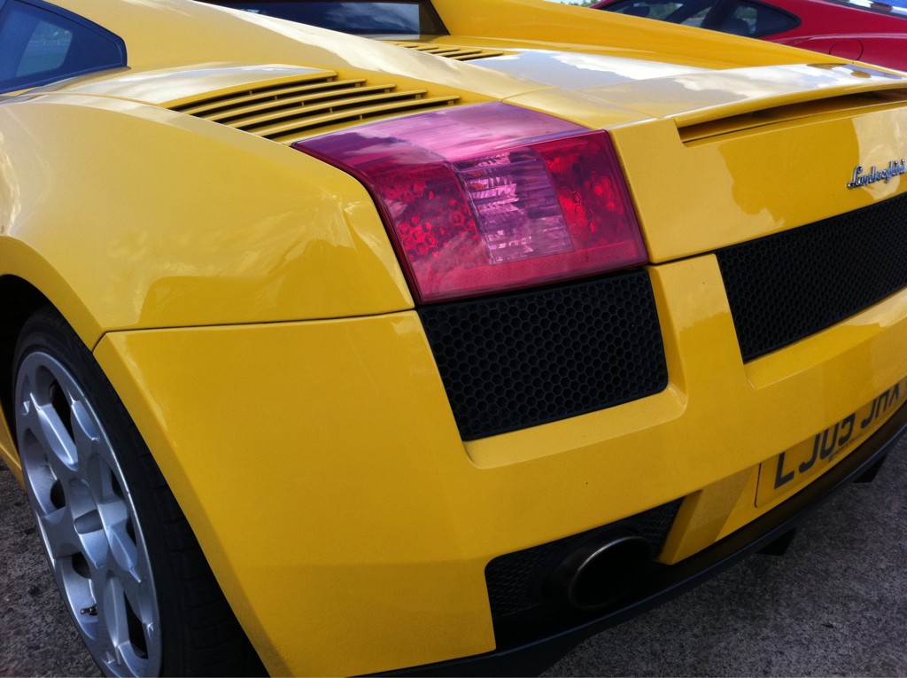 a close up of a yellow sports car's hood