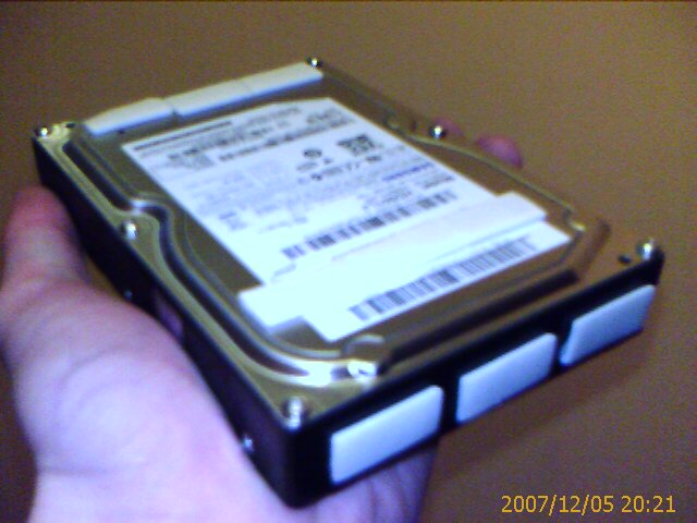 a hard drive being held by someone in the hand