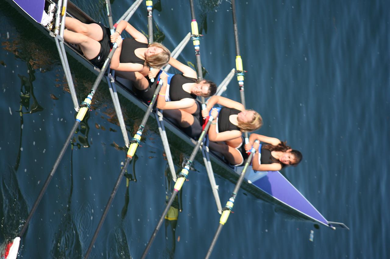 two teams of women rowing in a row on the water