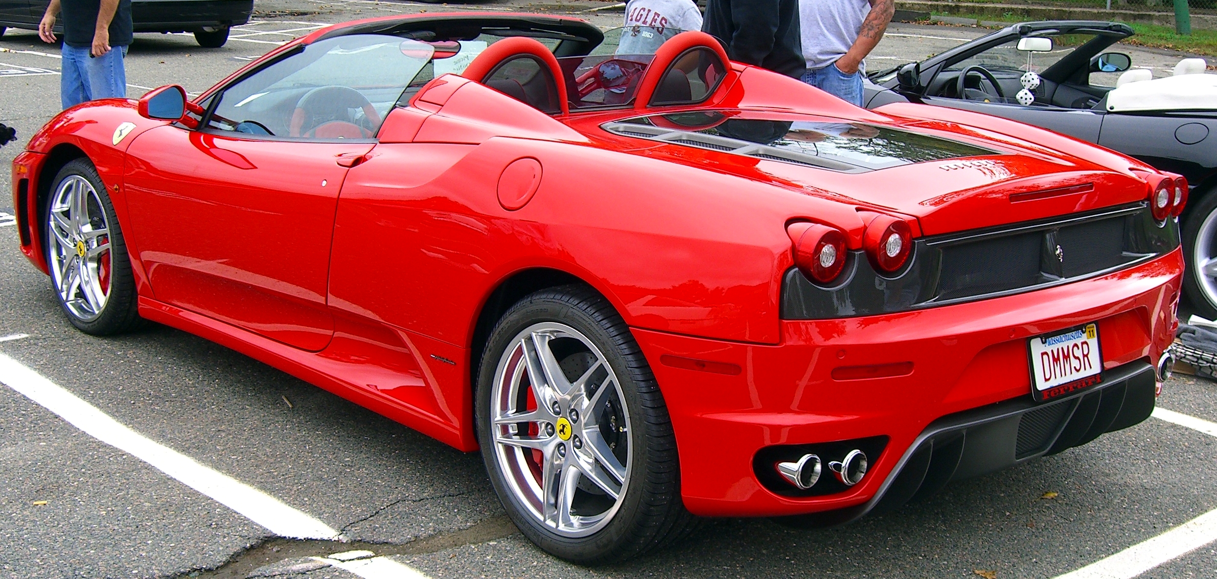 the sports car is parked near others in a parking lot