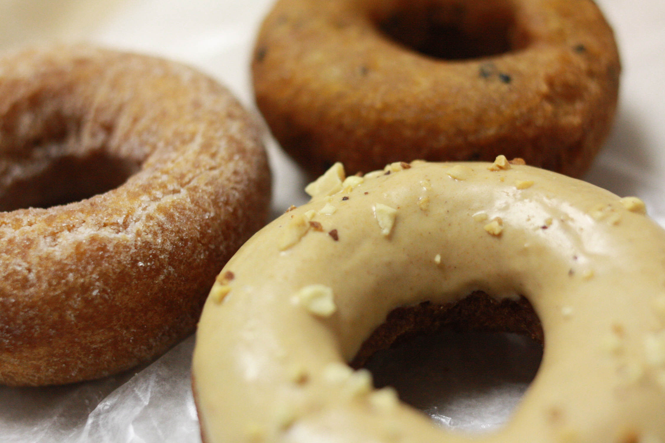 there are four donuts with icing on them