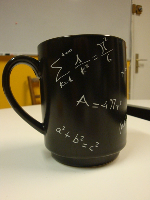 a black mug has many calculations written on it