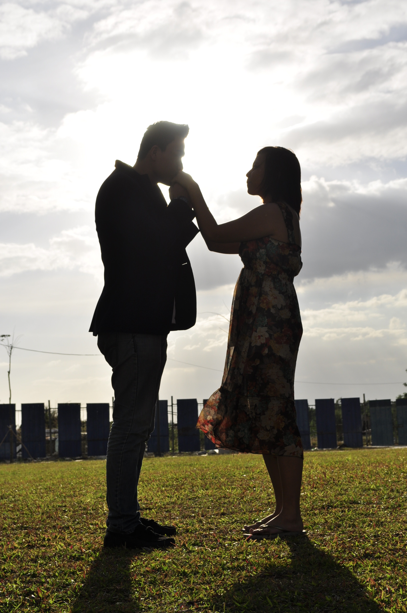 two people that are standing in the grass