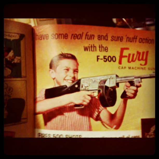 there is a poster with a boy holding a gun