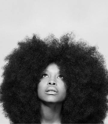 a woman with an afro in front of her