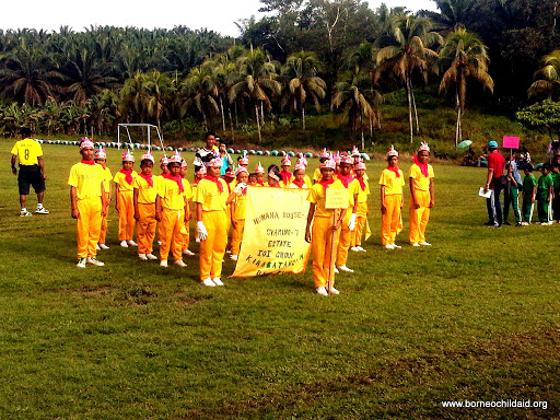 a group of people wearing yellow outfits and holding a yellow sign