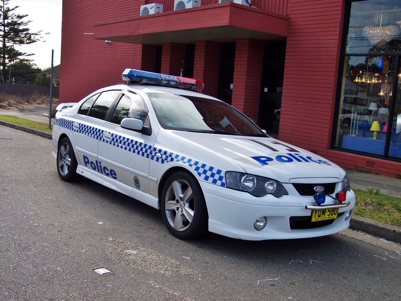 a police car parked on a street next to a building