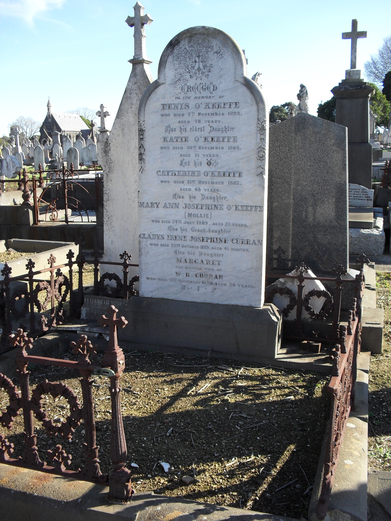 a cemetery on a sunny day with tombstones