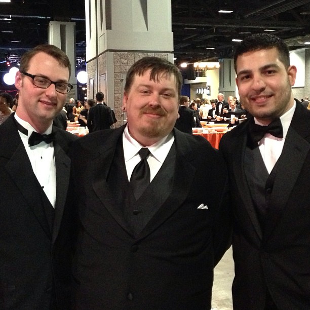 three men in tuxedos standing next to each other