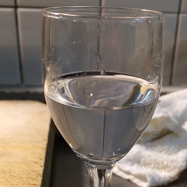 an empty glass sitting on top of a table
