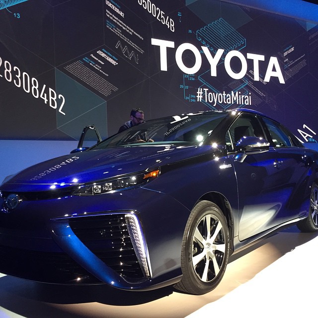toyota concept car displayed in front of a company advertit