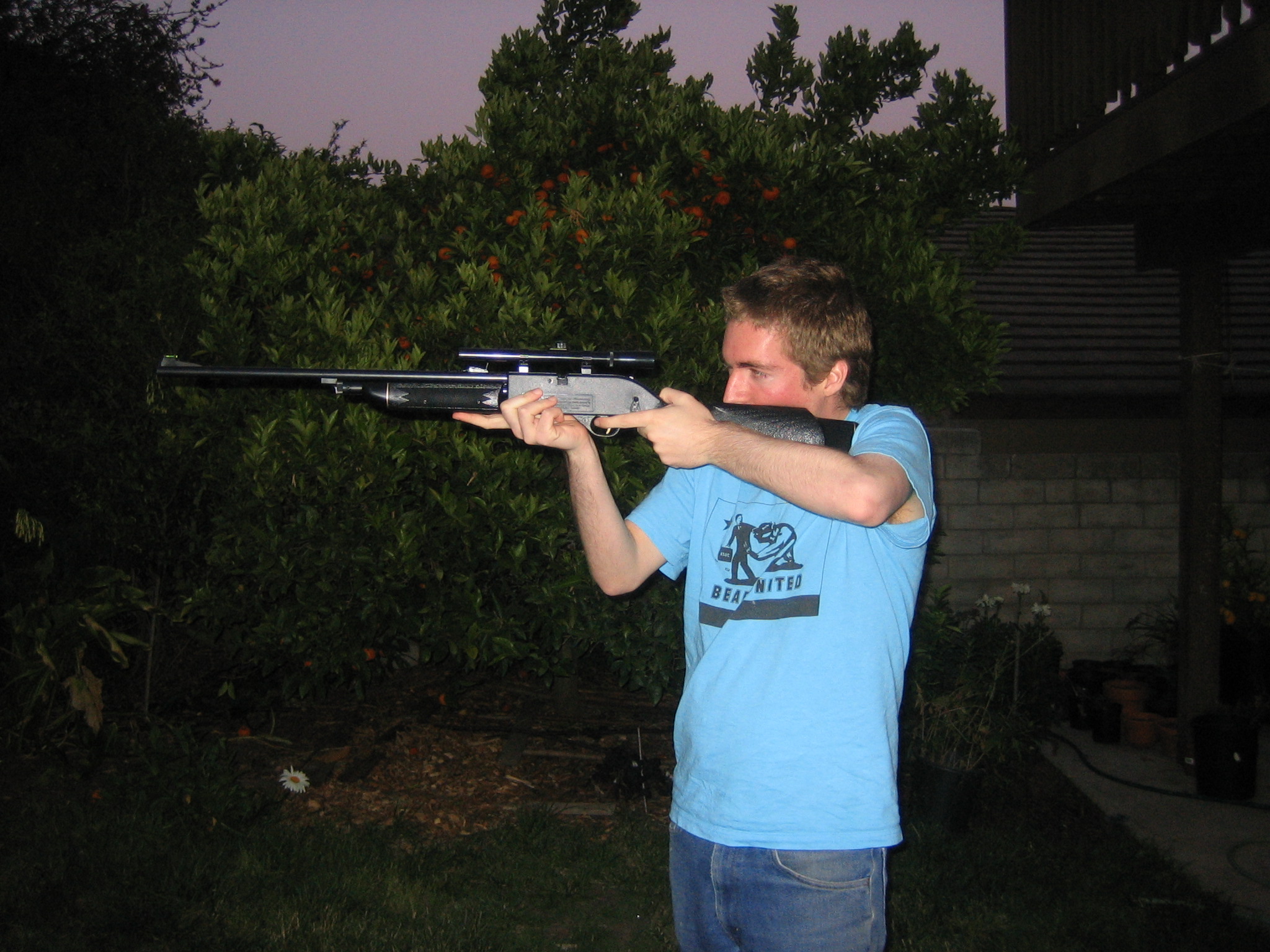 a man holding up an ak - p36 rifle to the camera