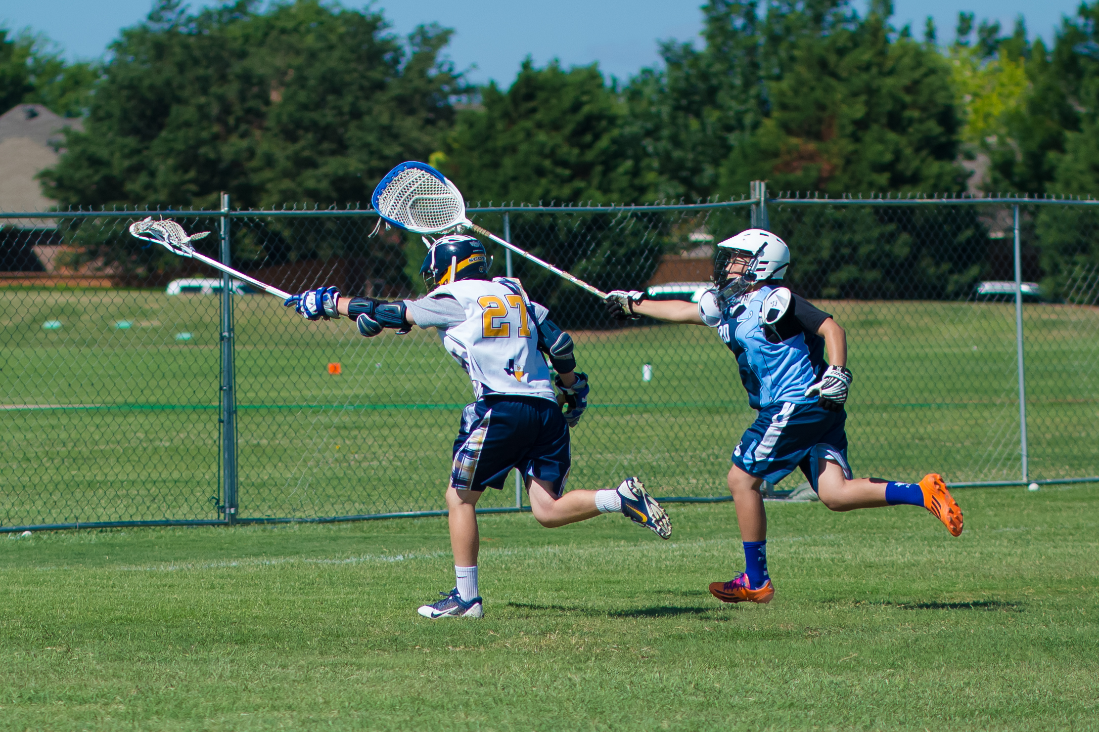 lacrosse players in action on the field playing a game